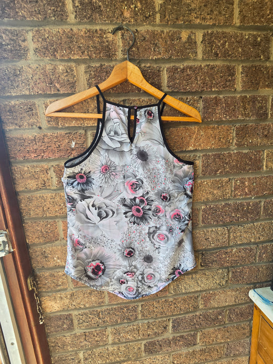 Iron and Flint grey floral cami top on wooden hanger showing back cage strap detail