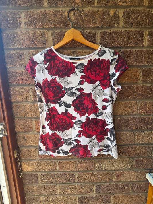 Close-up of Dorothy Perkins label showing size 10 UK 38 Euro inside neck of rose print top