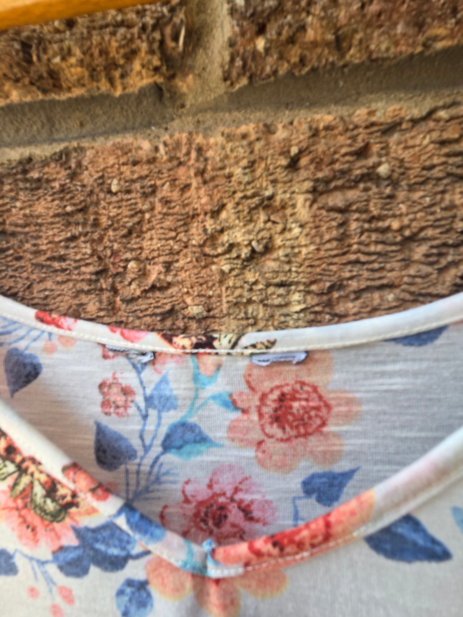 Close-up of neckline and straps of Dorothy Perkins butterfly floral cami top showing V neck detail