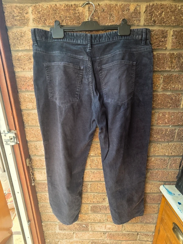 Tu Premium charcoal corduroy trousers - back view on hanger