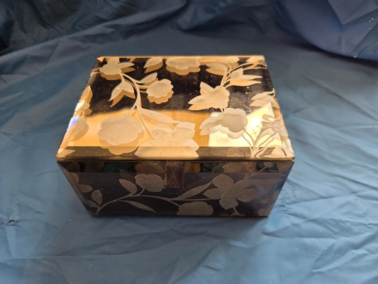 Vintage black and gold floral mirrored trinket box - closed lid showing etched floral detail